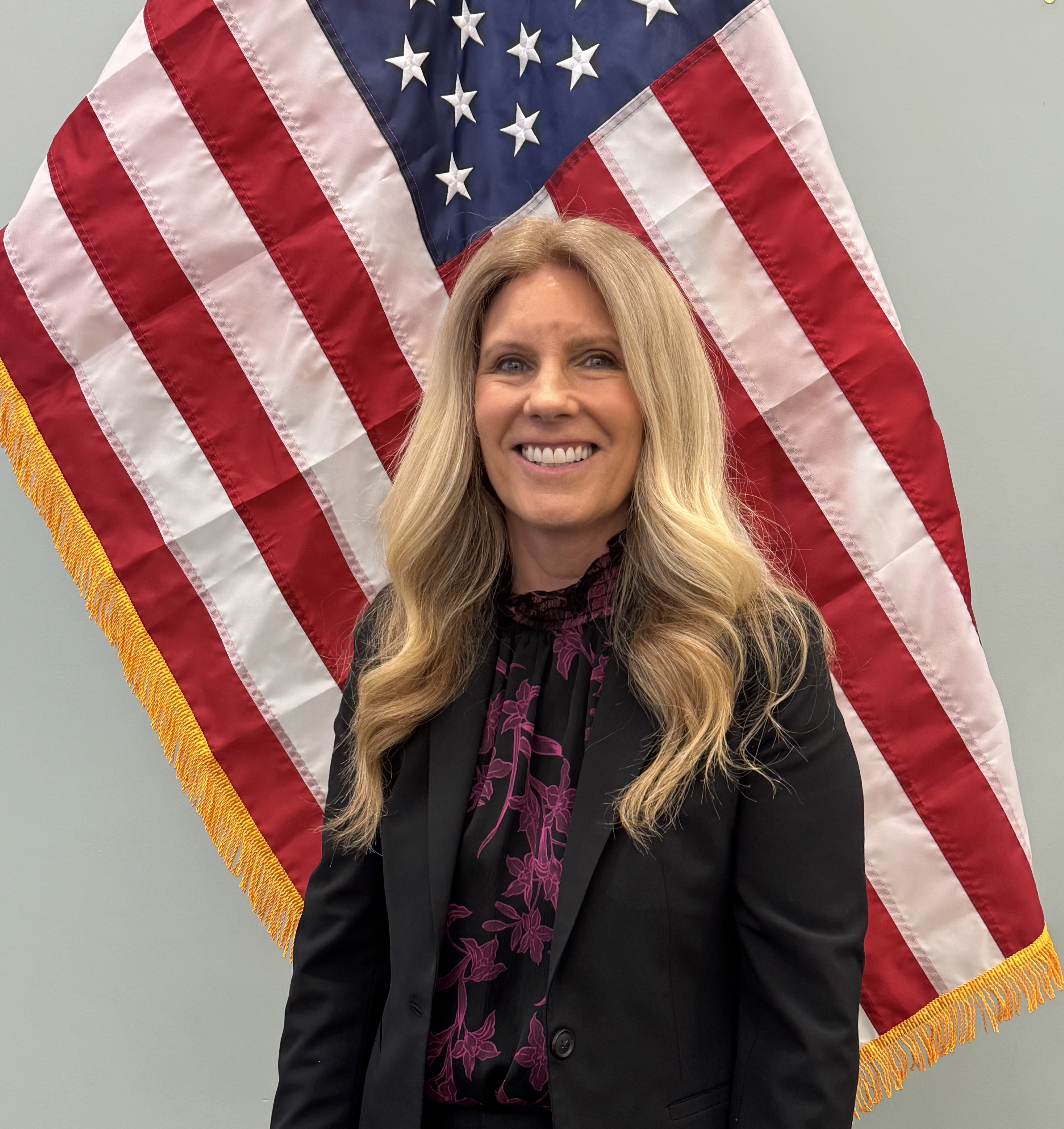 Kriten in front of an american flag.