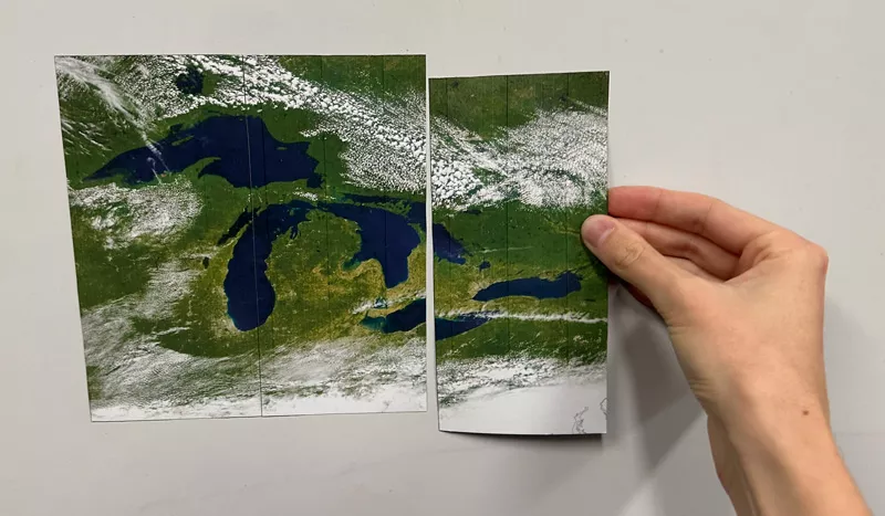 Photo of a hand holding a image strip next to set of matching image strips.