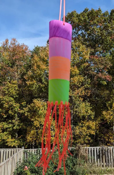 Photo of the completed construction of the windsock hanging outdoors.