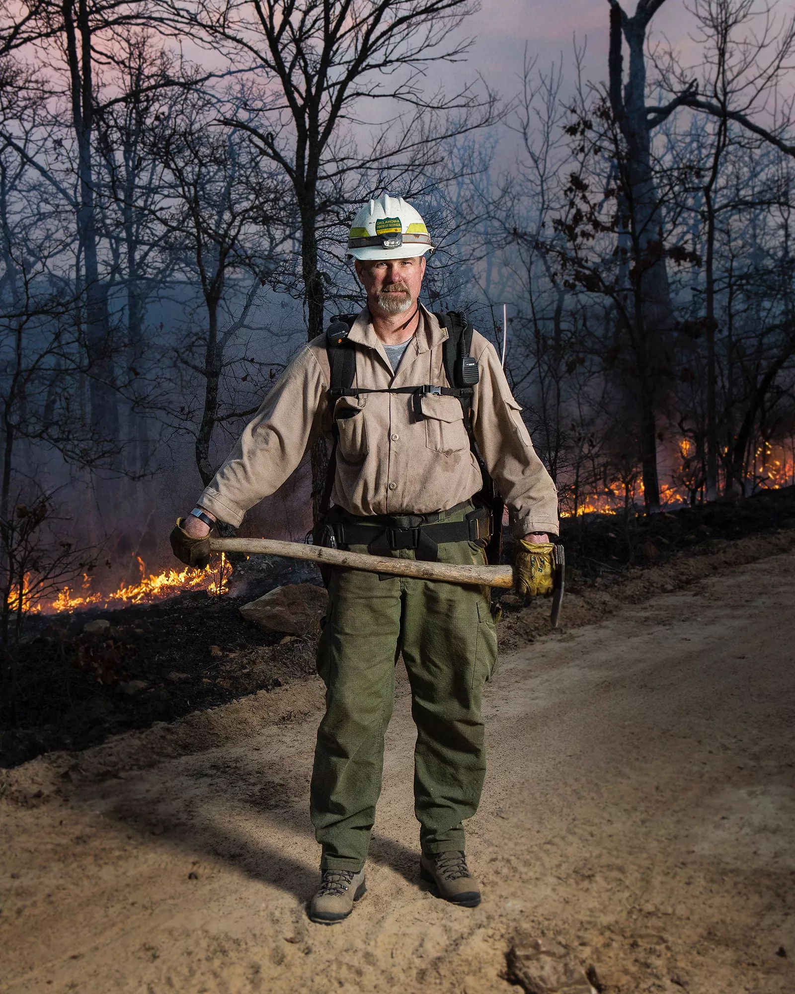 Drew Daily standing in a forest fire.