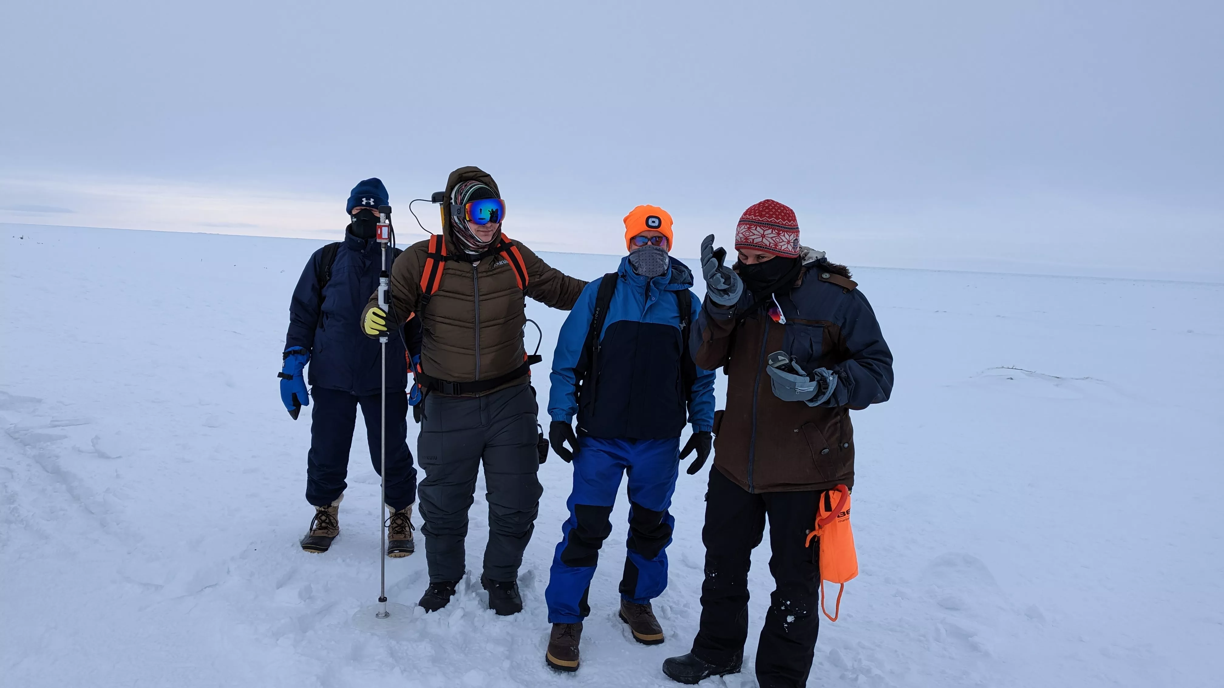 A group of men in the arctic in snow.