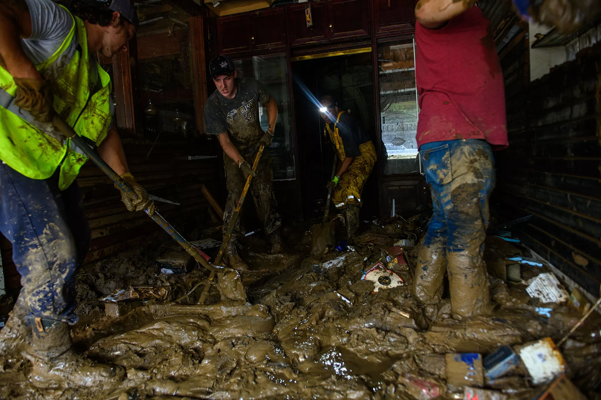 People digging in mud after hurricane Helene.