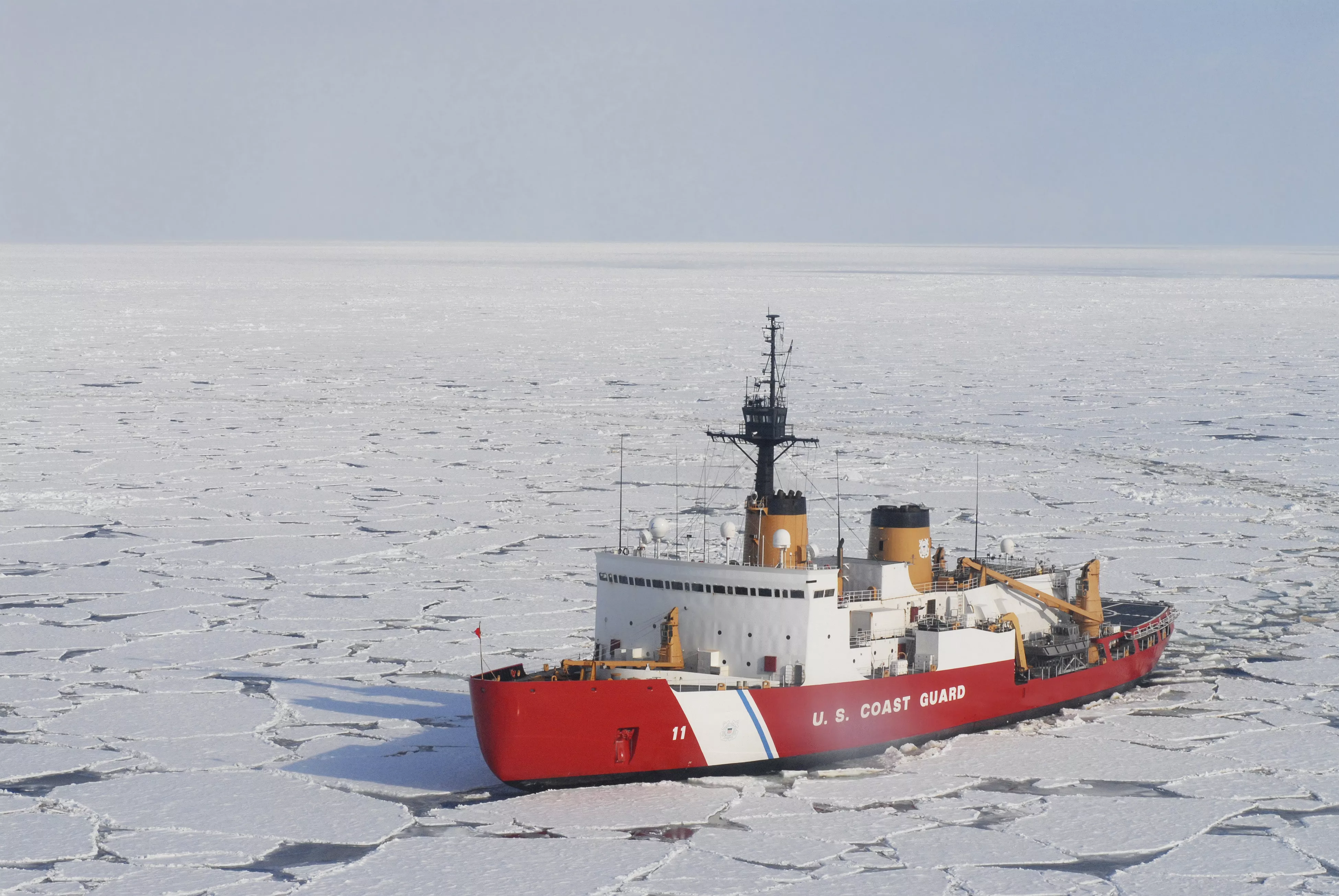 A ship in the ocean surrounded by ice.