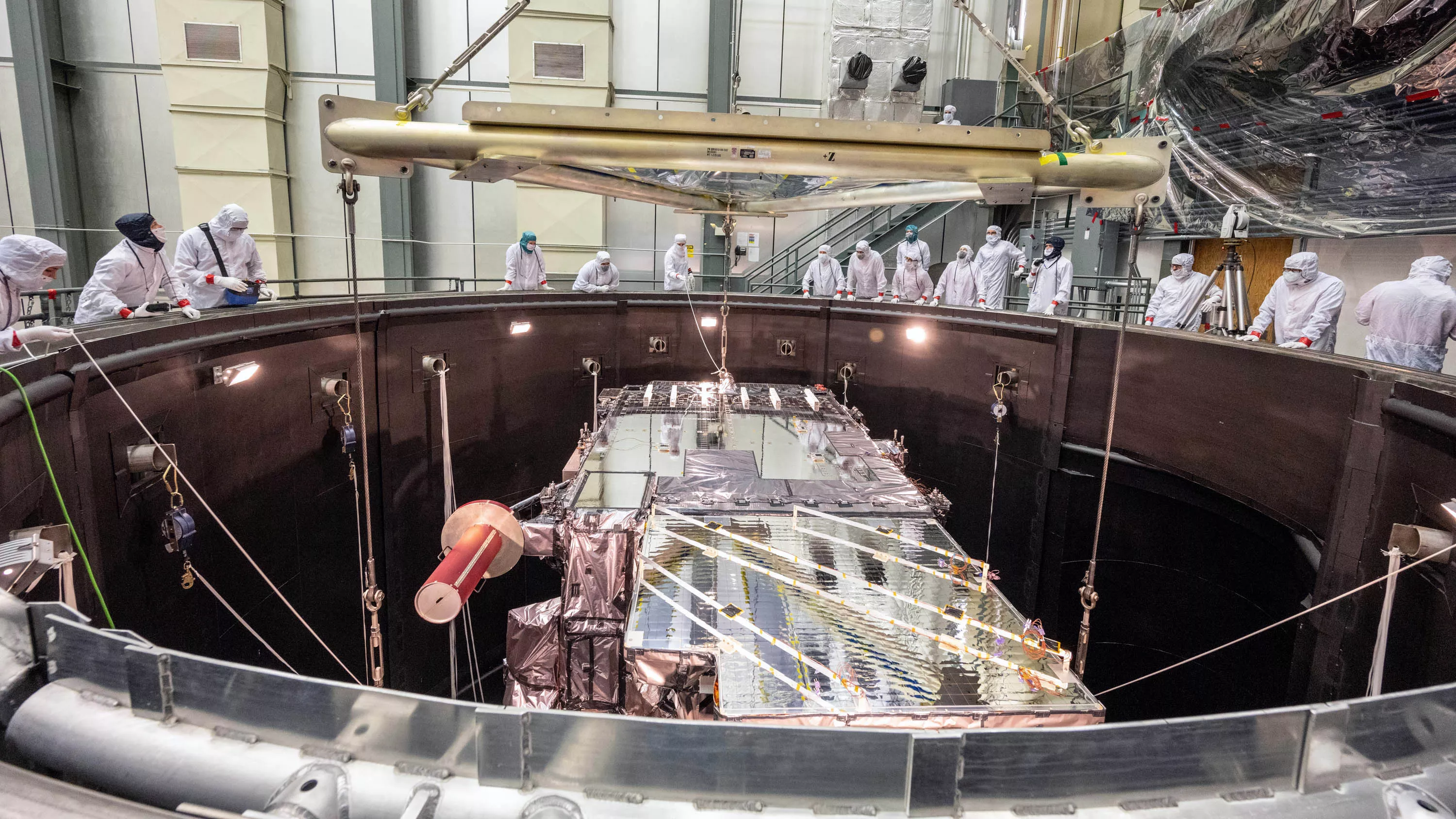 GOES-T is lowered into the thermal vacuum chamber.